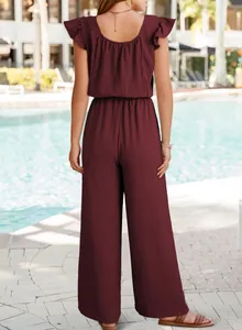 Back view of a maroon pleated jumpsuit featuring ruffle sleeves and wide-leg design