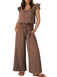 Close-up detail view of brown pleated sleeveless jumpsuit with ruffled sleeves and pockets