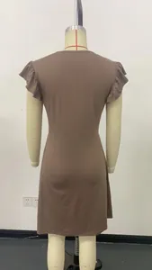 Detailed back view of a brown casual beach dress featuring feminine ruffled sleeves on a mannequin.