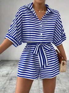 Detail view of casual blue and white striped button-front romper with waist tie belt