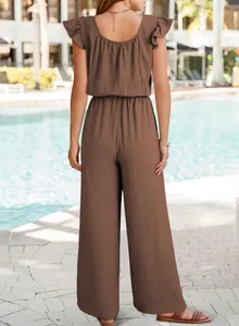 Back view of brown ruffled sleeve wide-leg jumpsuit in sunny poolside setting