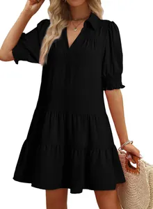 Detail view of black V-neck tiered mini dress with puff sleeves and textured fabric