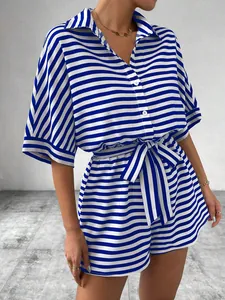 Detail view of blue and white striped shirt and shorts set with matching belt.