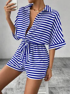 Detail shot of a blue and white striped romper with button-down collar and tie belt