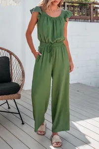 Full-length detail of a sage green ruffled jumpsuit with drawstring waist and wide legs