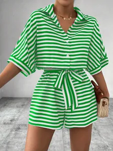 Close-up of a green and white striped button-down shirt and belted shorts set for women