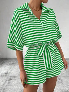 Detail view of women's green and white striped button-down romper with waist tie