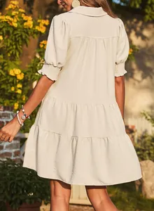Back view of a chic beige mini dress featuring ruffled tiers and puff sleeves
