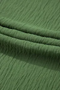 Macro detail showing the high-quality green crinkled fabric texture of women jumpsuit