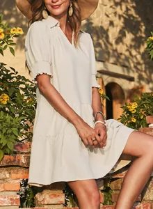 Elegant cream-colored V-neck dress with pleated puff sleeves and tiered skirt detail