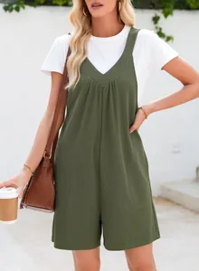 Detail of green waffle-knit sleeveless romper with side pockets and V-neckline.