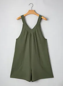Detail view of dark green waffle knit sleeveless romper with functional side pockets.