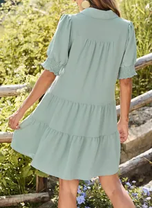 Back view detail of sage green tiered dress with pleated texture and V-neck collar.