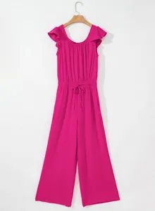 Detail view of a vibrant magenta sleeveless jumpsuit featuring ruffled sleeves and a drawstring waist.