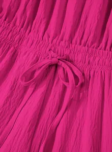 Close-up of fuschia pink pleated jumpsuit with elasticated drawstring waist details