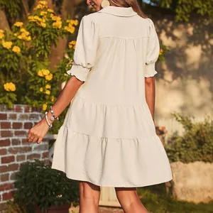 Elegant beige tiered mini dress featuring puff sleeves and a classic collared V-neckline