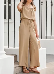 Detailed view of khaki sleeveless wide-leg jumpsuit with ruffled shoulder and drawstring waist