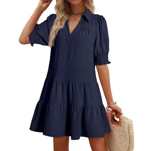 Elegant navy blue tiered dress with V-neck collar and ruffled short puff sleeves.