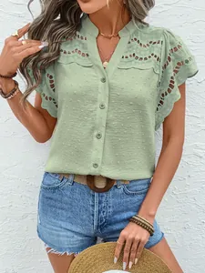 Detail of sage green lace eyelet blouse with button-front and textured Swiss dot fabric