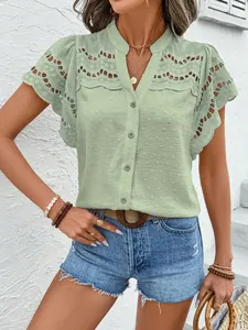 Detailed view of light green lace hollow-out button-up blouse with textured fabric