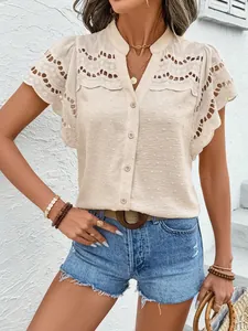 Close-up of elegant beige lace trim blouse with pom-pom texture and button-down detail