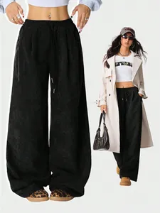 Detailed view of high waisted black corduroy wide-leg trousers for a casual outfit.
