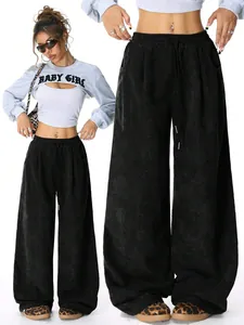 Detailed macro view of black corduroy wide leg trousers featuring an adjustable drawstring waist