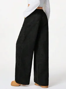 Detailed back view of high-waisted black corduroy wide-leg pants with casual drape