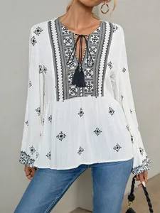 Detailed shot of retro ethnic blouse with tassels and intricate embroidery patterns