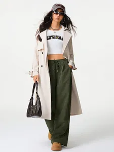 Close-up of stylish green wide-leg corduroy pants with a drawstring high waist for women