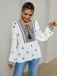 Boho vintage white blouse with ethnic embroidery, tie neck and lantern sleeves.