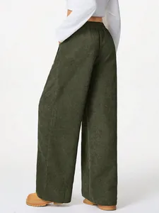 Close-up view of high waist dark green corduroy wide leg trousers in a slouchy style