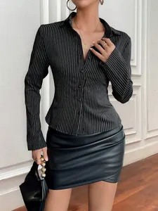 Detailed shot of a women's black and white vertical striped V-neck long sleeve blouse