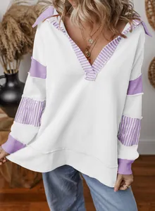 Detailed view of a white oversized V-neck sweatshirt with purple striped accents