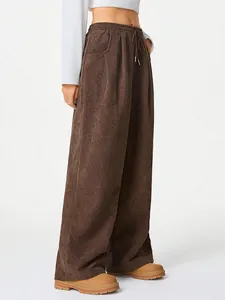 Side view of brown corduroy wide-leg pants with high waist and drawstring detail