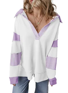Close-up of deep V-neck and purple striped patchwork on a white loose sweatshirt