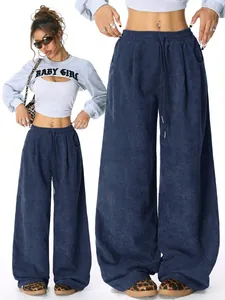 Close-up of navy blue high-waisted corduroy wide-leg trousers with drawstring waist