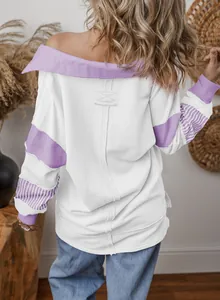 Back view of a loose white and purple color-block sweatshirt with trendy striped cuffs