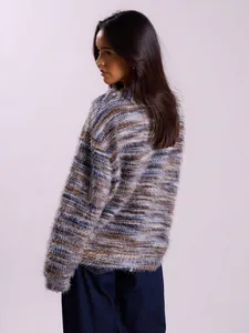 Back view of a fuzzy multi-colored knit sweater featuring soft Maillard tones.