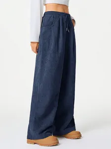 Detailed view of high-waisted navy corduroy wide-leg trousers with drawstring waist