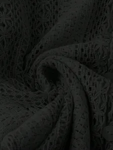 Gros plan détaillé de la texture dentelle florale noire ajourée et motifs crochet