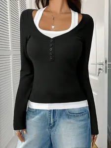 Detail view of the black and white halter fake two-piece top with buttons