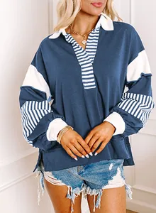Detail of casual V-neck sweatshirt featuring striped patchwork and oversized fit design
