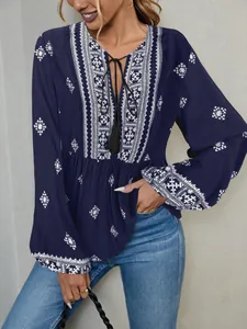 Detail view of bohemian embroidered tassel blouse with stylish lantern sleeves