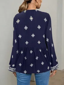 Back view of a navy blue ethnic print blouse with balloon sleeves and ruffled hem