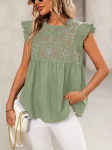 Gedetailleerd beeld van groene etnisch geborduurde blouse met ruches op een model