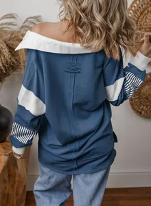 Stylish back view of a blue oversized color-block sweatshirt with striped sleeves