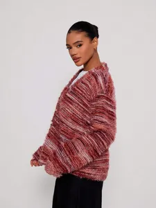 Detail view of a retro fuzzy striped cardigan with shaggy texture and rich warm tones.
