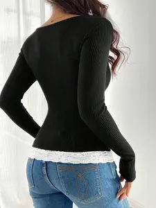 Back view of a slim fit black ribbed long sleeve top with elegant white lace hem detailing