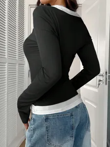 Detailed side view of a black and white layered long sleeve top with a slim fit design